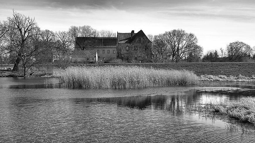 Black and white landscape of Castle Klöden by a river