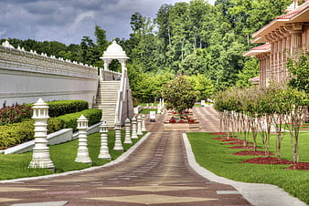 Pathway with white pillars leading to temple architecture