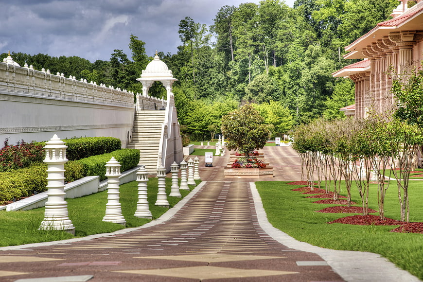 Pathway with white pillars leading to temple architecture
