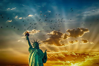 Statue of Liberty at Sunset with Birds and Sun Rays