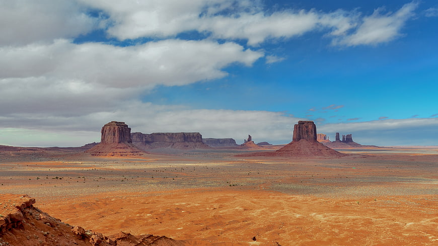 Wide Landscape of Monument Valley Red Rock Buttes Under Blue Sky
