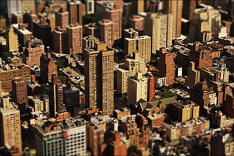 Aerial tilt-shift view of dense urban cityscape with skyscrapers