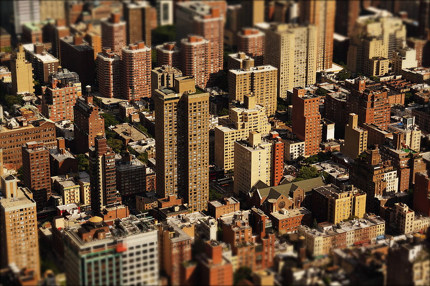 Aerial tilt-shift view of dense urban cityscape with skyscrapers