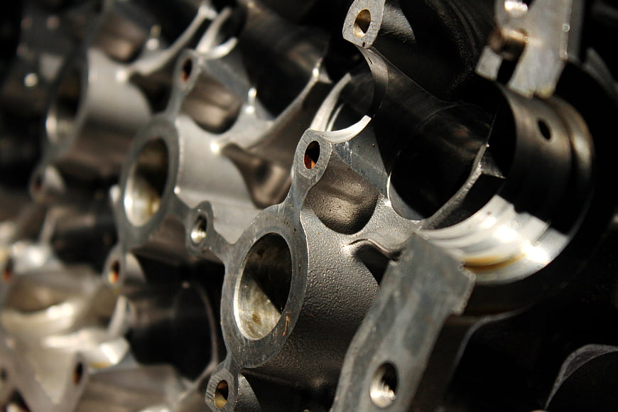 Close-up of metallic engine cylinder block with bokeh background
