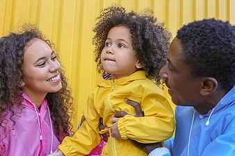Happy Black Family in Colorful Raincoats