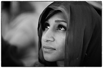 Black and white portrait of woman in hijab looking up