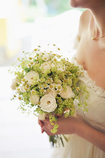 Bride holding white and green floral bouquet close-up