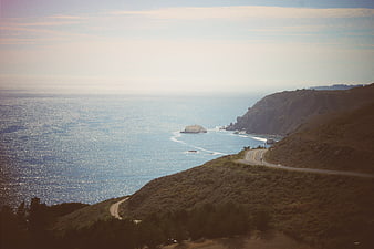 Winding coastal highway along rugged cliffs overlooking the ocean