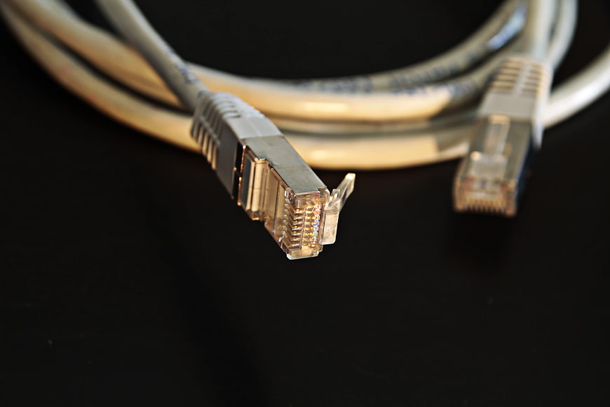 Close-up of white ethernet cable connectors on black background
