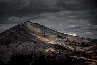 Dramatic Mountain Peak Under Stormy Clouds