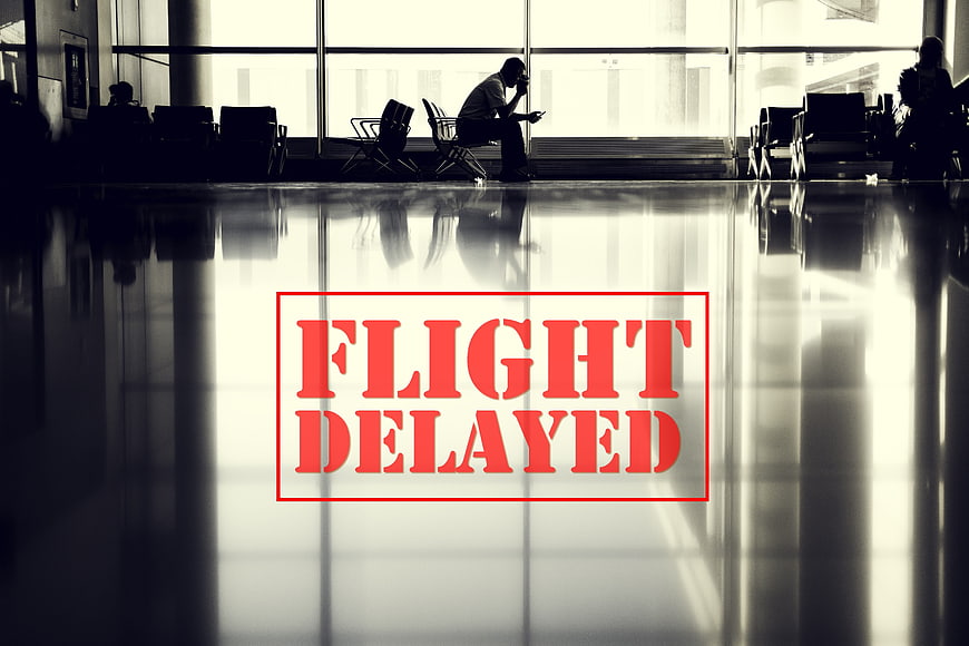 Flight Delayed Text Overlay On Silhouette Of Tired Passenger In Airport Terminal
