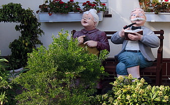 Garden Statues of Elderly Couple Sitting on Bench