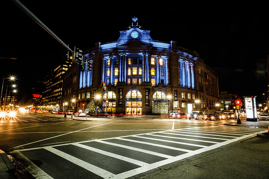 Nighttime Cityscape of Illuminated Historic Building with Traffic