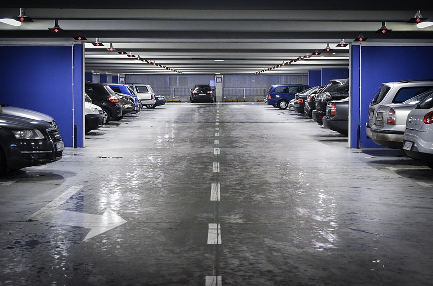 Underground parking garage with cars and blue walls