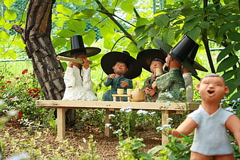 Traditional Korean Clay Figurines in Garden Setting