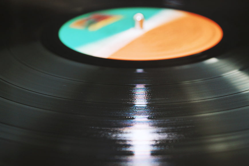 Close-up of vinyl record with colorful label and light reflection