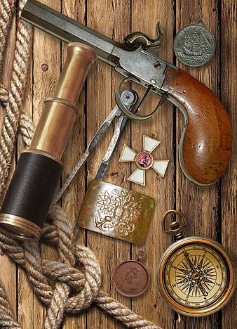 Vintage nautical pirate still life with flintlock pistol and compass