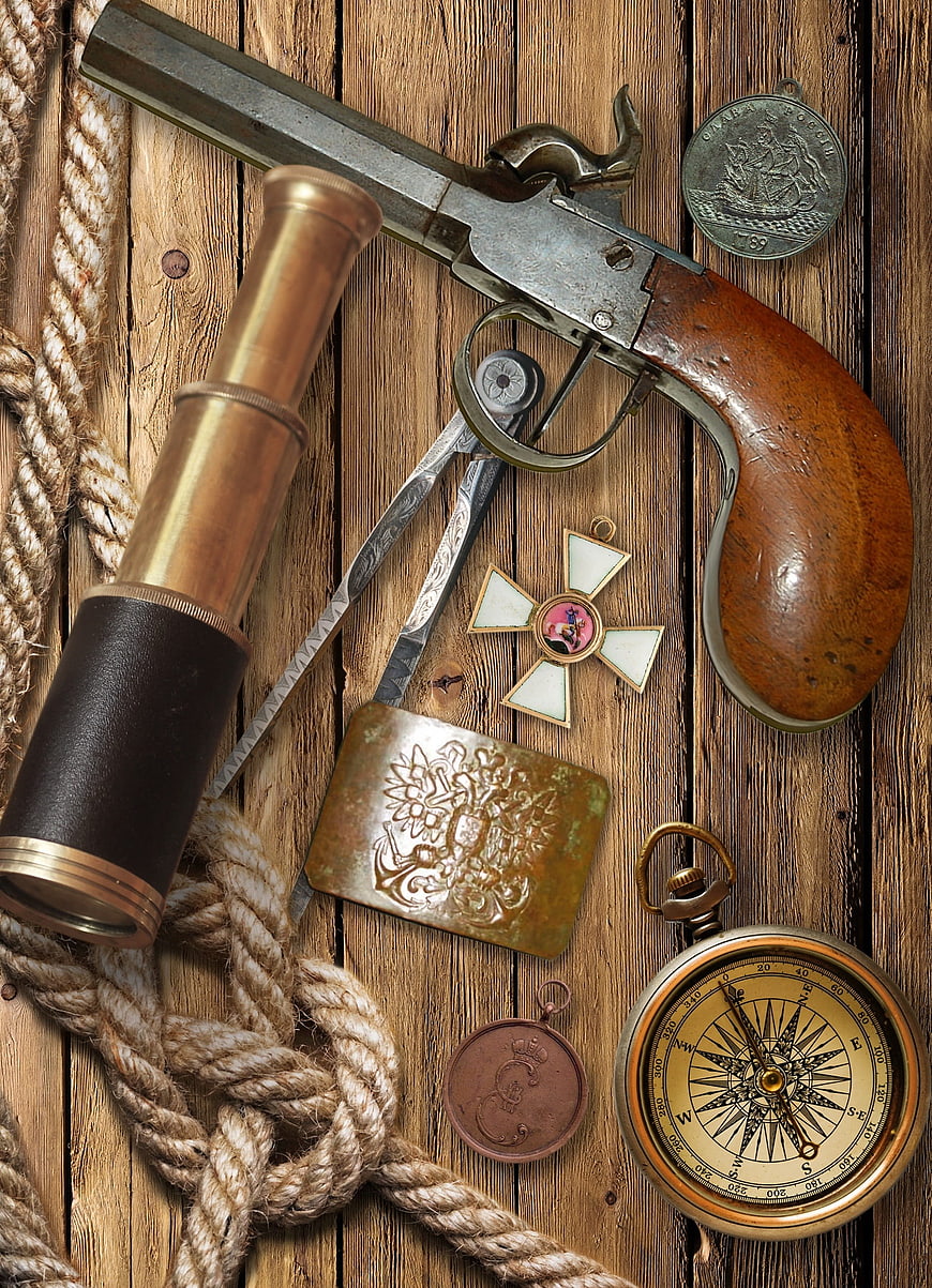 Vintage nautical pirate still life with flintlock pistol and compass