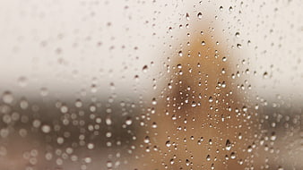 Raindrops on a Window Pane with Blurred Background