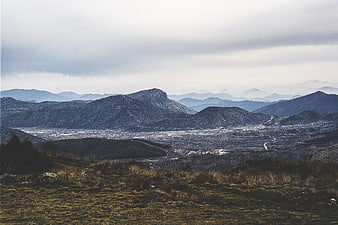 Panoramic mountain landscape with valley and overcast sky