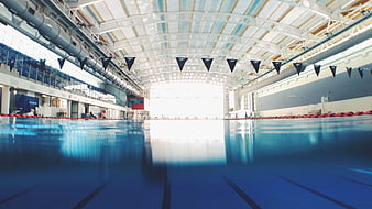 Empty Indoor Olympic Swimming Pool with Blue Water