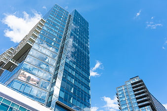 Modern Glass Skyscraper Against Blue Sky