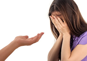 Sad woman covering face while receiving a helping hand