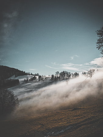 Misty Winter Morning in Snowy Mountain Valley