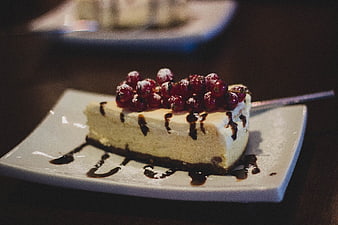 Cheesecake Slice with Red Currants and Chocolate Drizzle