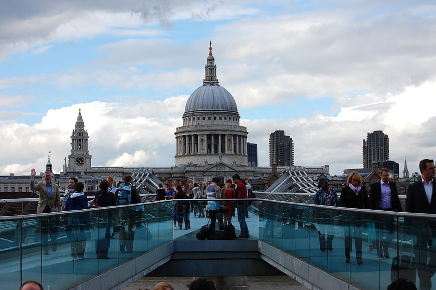 Crowds walking on Millennium Bridge with St Paul's Cathedral