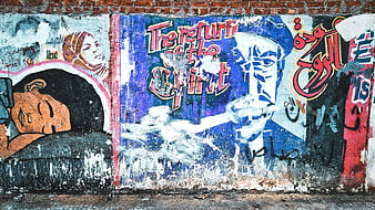 Weathered Street Art Mural on Brick Wall