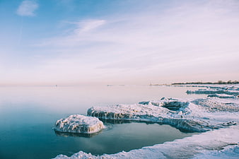 Frozen Ice Formations on a Calm Winter Lake Shore