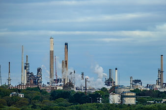 Wide shot of an oil refinery with smokestacks and industrial structures