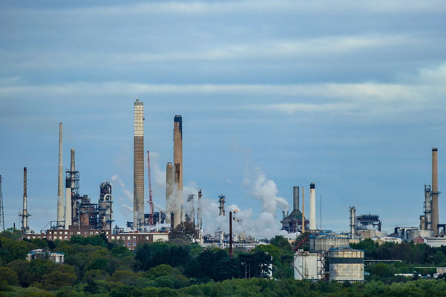 Wide shot of an oil refinery with smokestacks and industrial structures