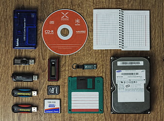 Flat lay of vintage computer storage devices on wood