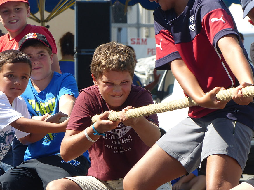 Boys competing in a tug-of-war game outdoors