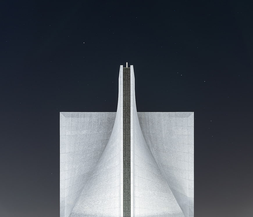 Futuristic white architectural structure against starry night sky