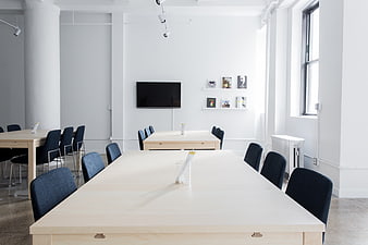 Modern minimalist office meeting room with wooden tables