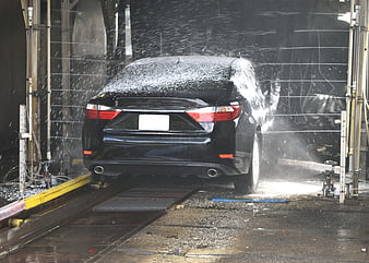 Black Sedan Being Washed in Automatic Car Wash Tunnel