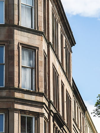 Low angle view of historic stone building facade against blue sky
