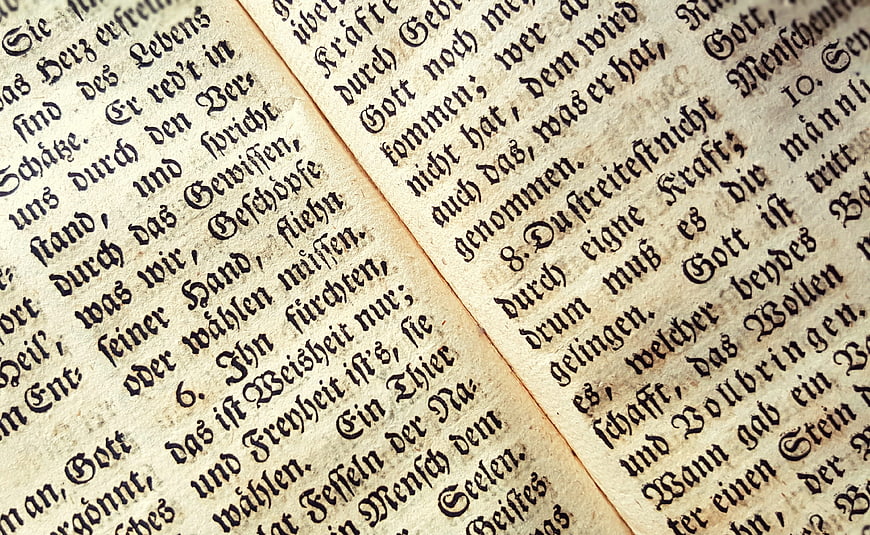 Close-up of antique German hymn book page with Fraktur text
