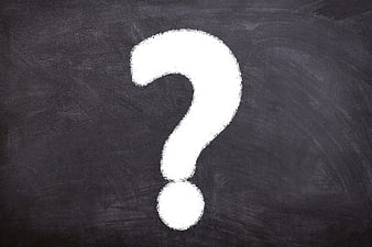 White Chalk Question Mark On Dark Blackboard Background