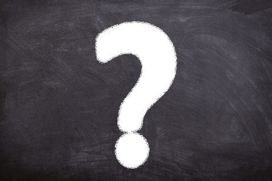White Chalk Question Mark On Dark Blackboard Background