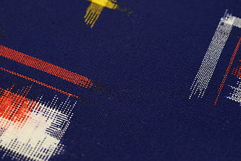 Close-up of blue woven textile with red and white geometric pattern
