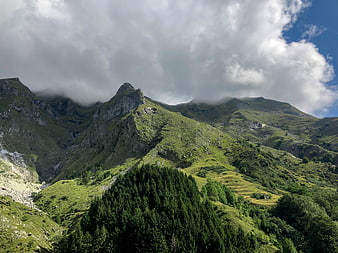 Majestic Green Mountain Peaks with Clouds and Forest