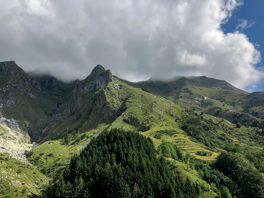 Majestic Green Mountain Peaks with Clouds and Forest