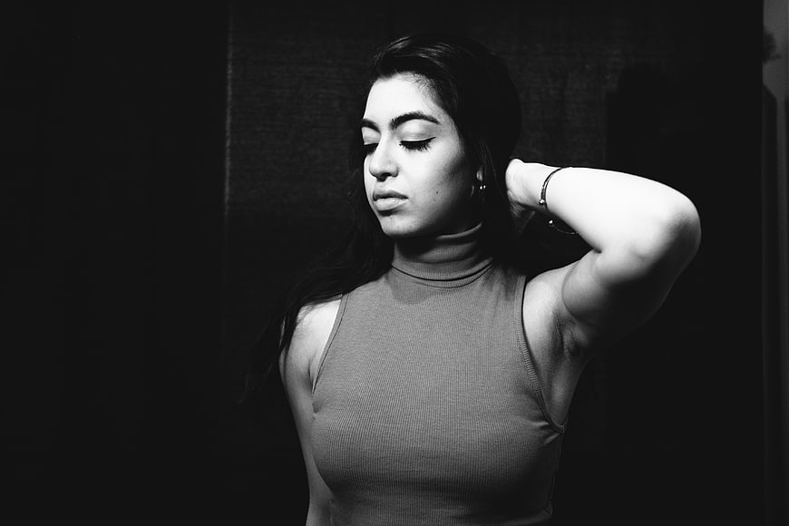 Dramatic black and white portrait of a woman with eyes closed