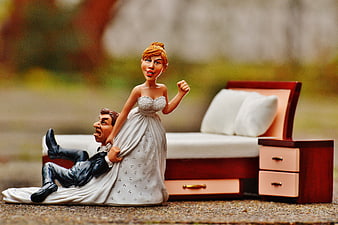 Humorous Wedding Cake Topper with Bride Dragging Groom