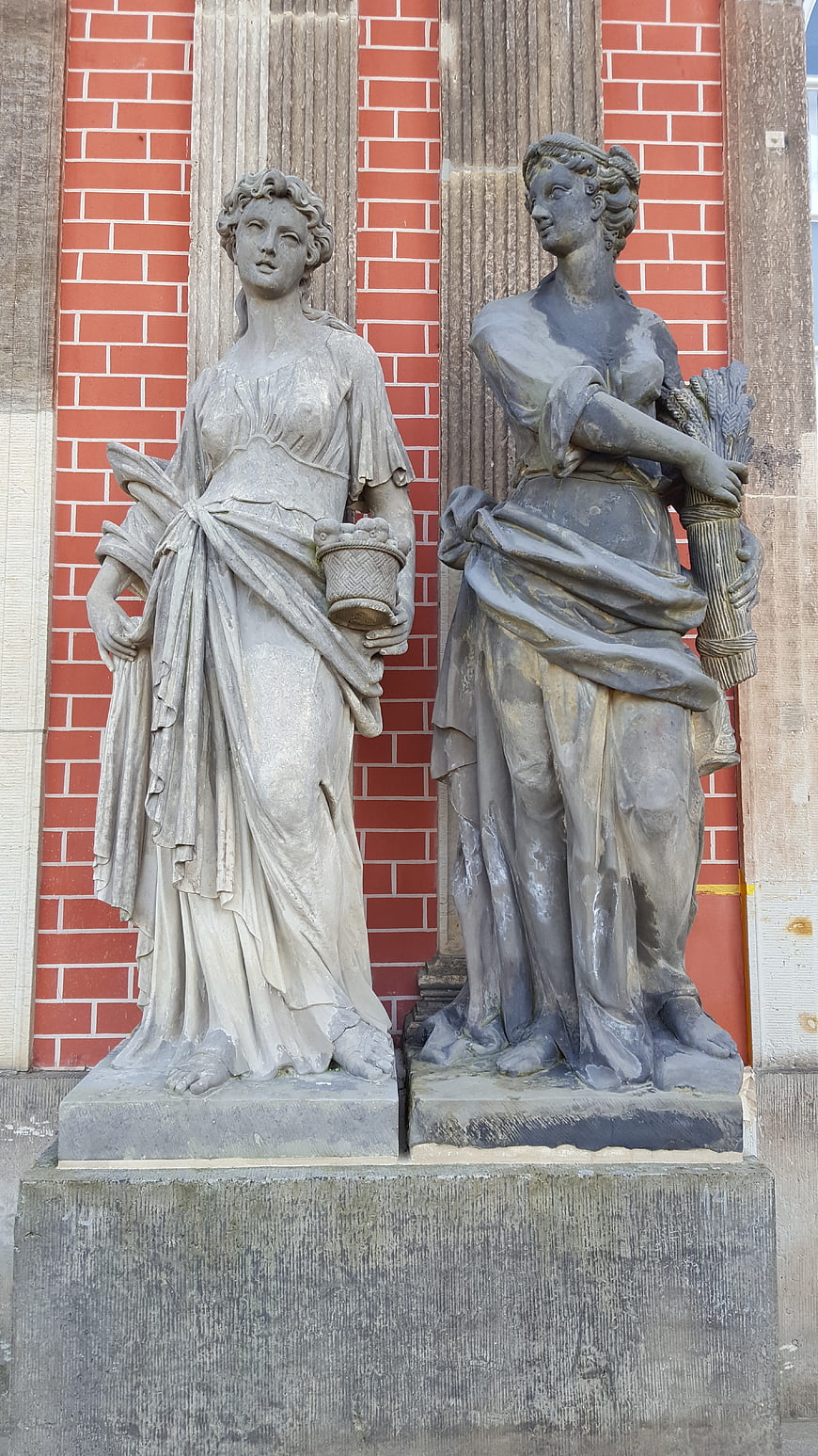 Two Classical Female Stone Statues on Pedestals
