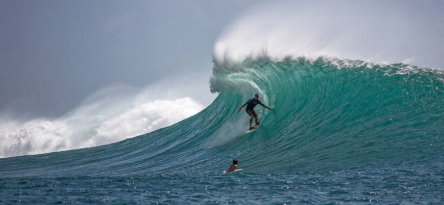 Surfer Riding Massive Barrel Wave in Ocean